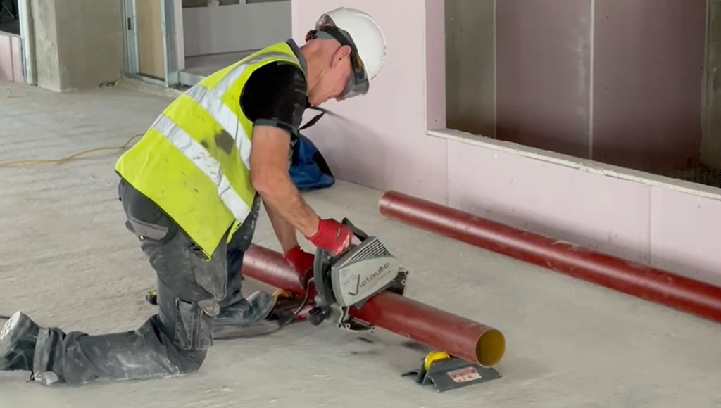 Coventry construction in progress at TWO FRIARGATE with construction worker cutting metal tubing to size