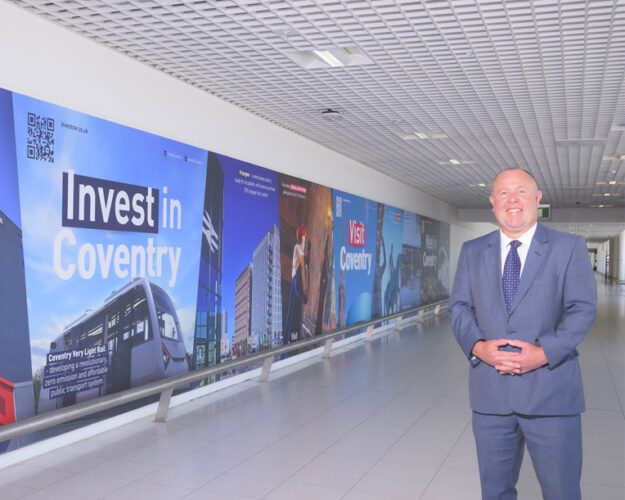 Destination Coventry's wall graphic at Birmingham Airport featuring TWO Friargate with Cllr Jim O’Boyle