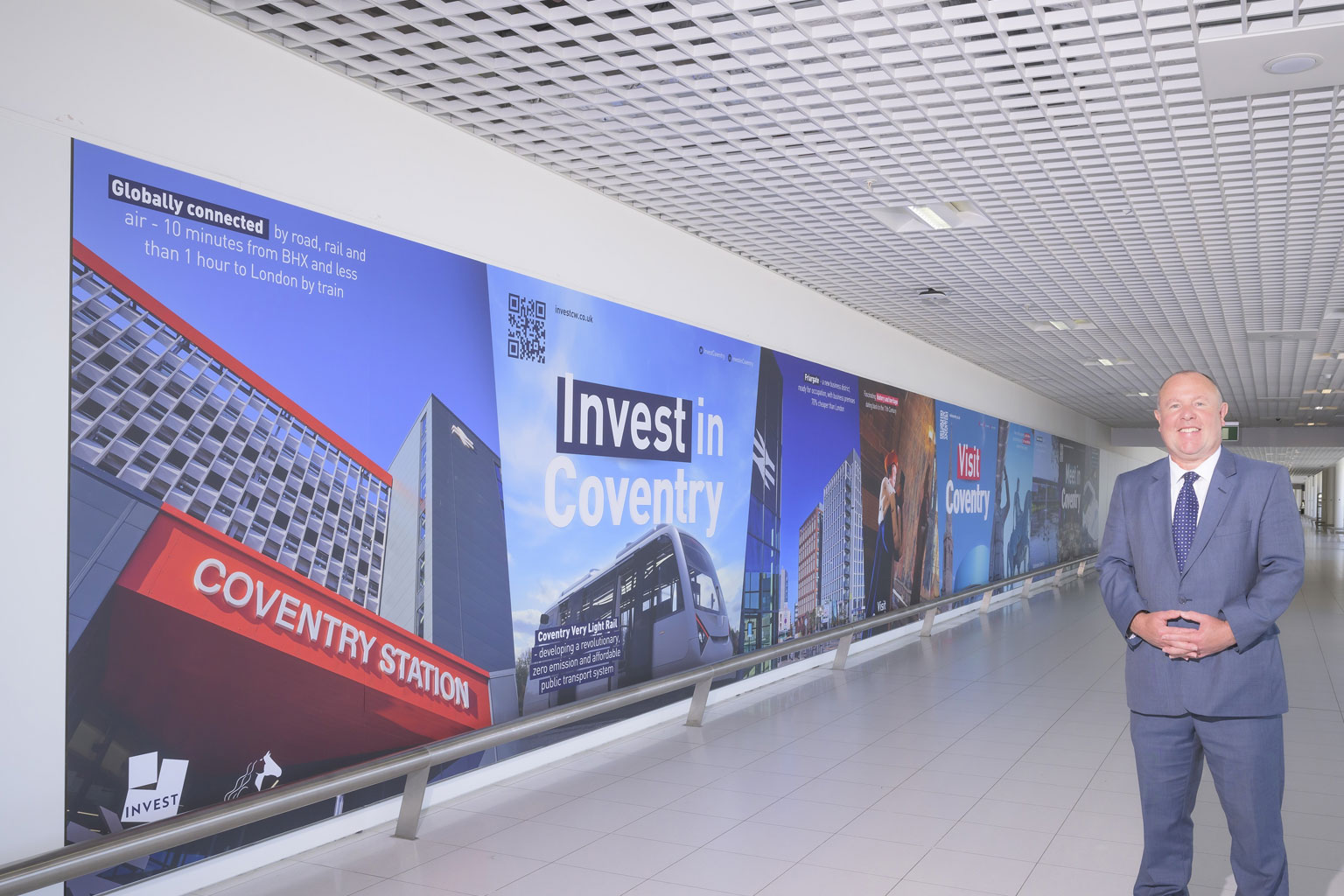 Destination Coventry's wall graphic at Birmingham Airport featuring TWO Friargate with Cllr Jim O’Boyle